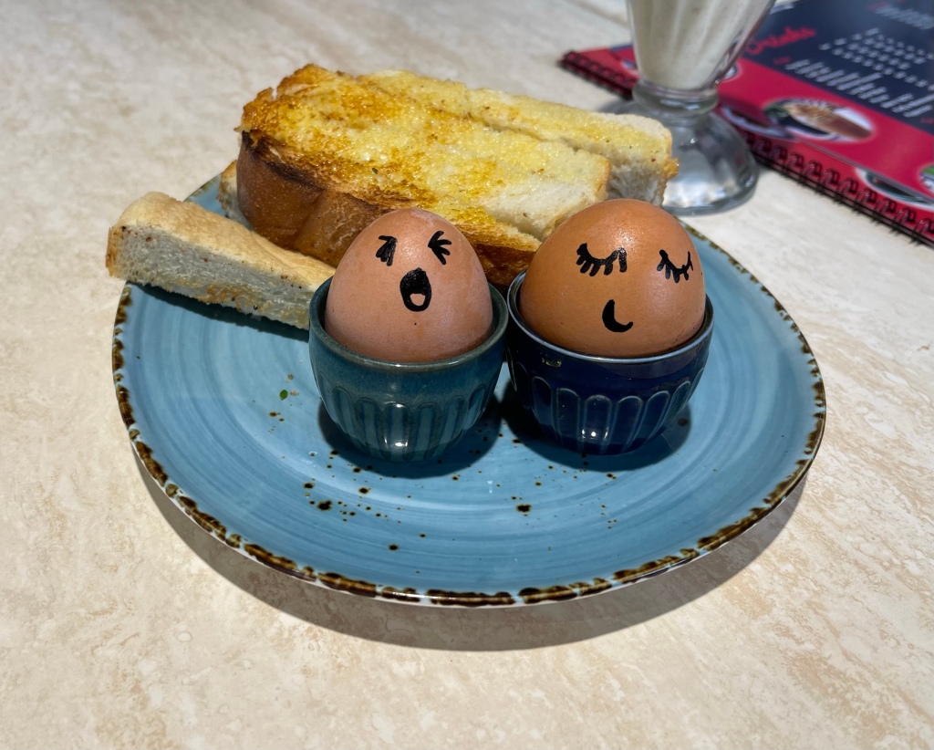 Boiled eggs and toast soldiers.  The cool part is they have drawn smiley faces on the eggs.  One asleep and the other awake!